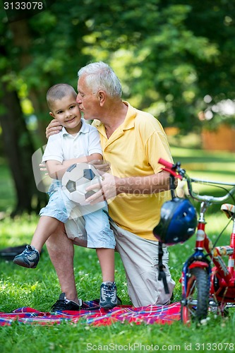 Image of grandfather and child have fun  in park