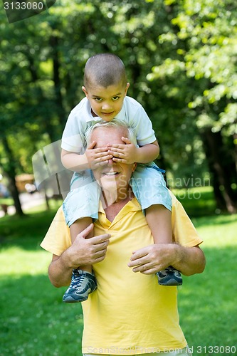 Image of grandfather and child have fun  in park