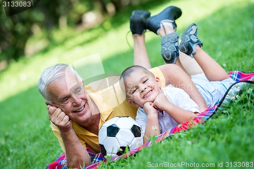 Image of grandfather and child have fun  in park