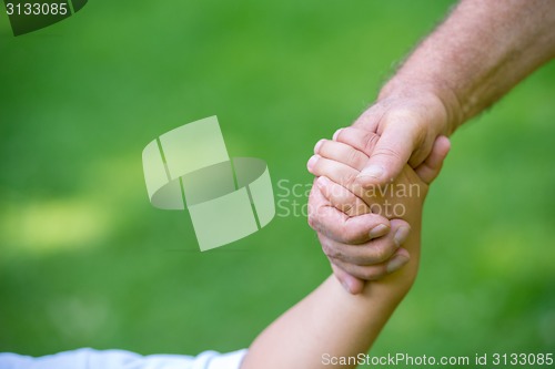 Image of grandfather and child have fun  in park