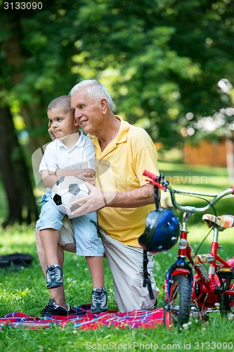 Image of grandfather and child have fun  in park