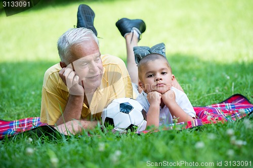 Image of grandfather and child have fun  in park