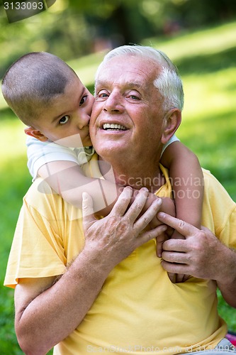 Image of grandfather and child have fun  in park