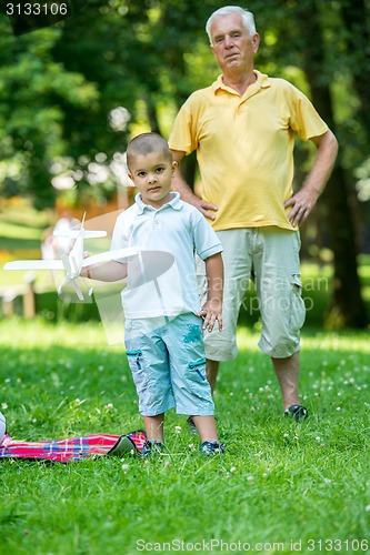 Image of grandfather and child have fun  in park