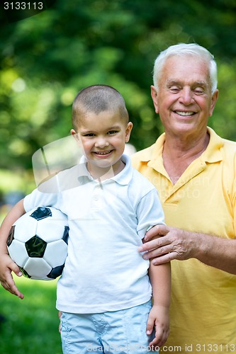 Image of grandfather and child have fun  in park