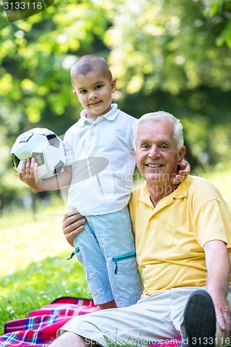 Image of grandfather and child have fun  in park