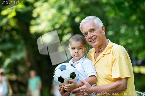 Image of grandfather and child have fun  in park