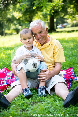 Image of grandfather and child have fun  in park