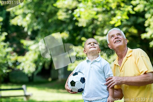 Image of grandfather and child have fun  in park