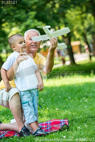 Image of grandfather and child have fun  in park