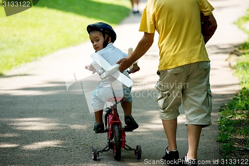 Image of grandfather and child have fun  in park