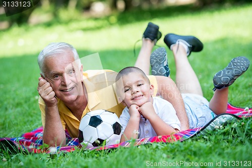 Image of grandfather and child have fun  in park