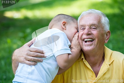 Image of grandfather and child have fun  in park