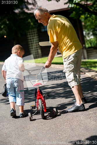 Image of grandfather and child have fun  in park