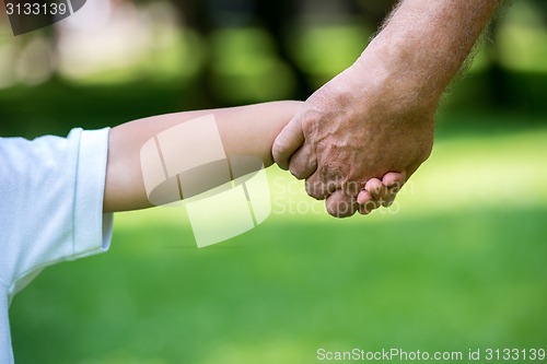 Image of grandfather and child have fun  in park