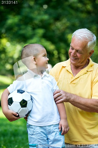 Image of grandfather and child have fun  in park