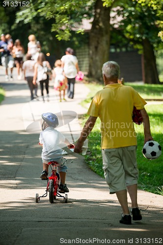 Image of grandfather and child have fun  in park