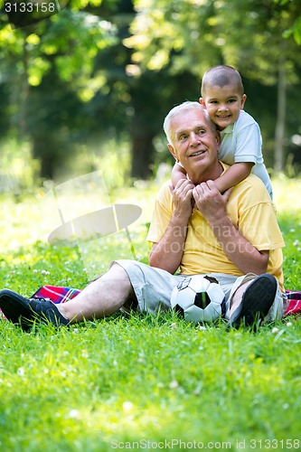 Image of grandfather and child have fun  in park