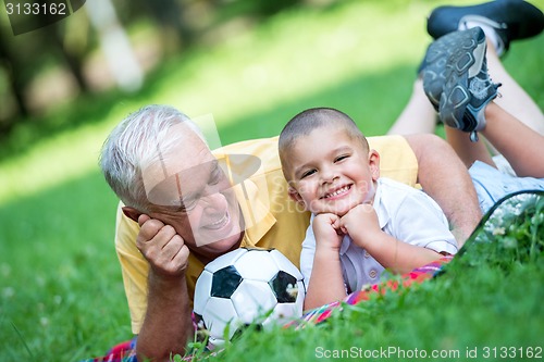 Image of grandfather and child have fun  in park