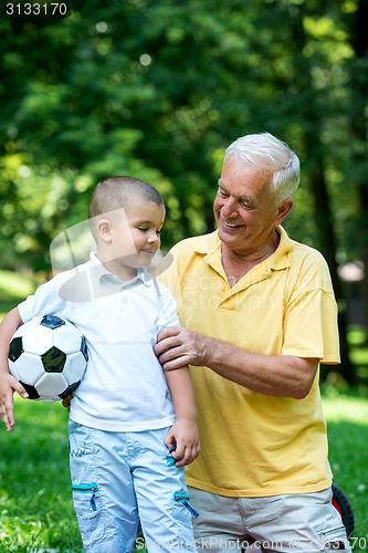 Image of grandfather and child have fun  in park