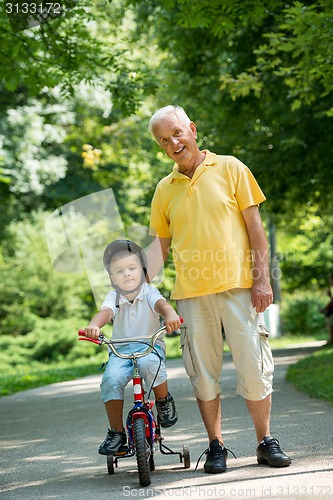 Image of grandfather and child have fun  in park