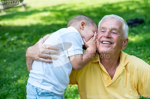 Image of grandfather and child have fun  in park