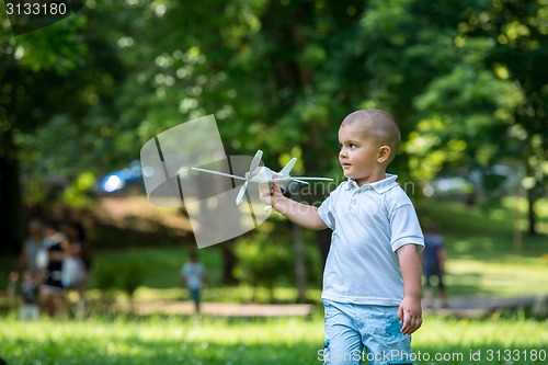 Image of boy with airpane toy