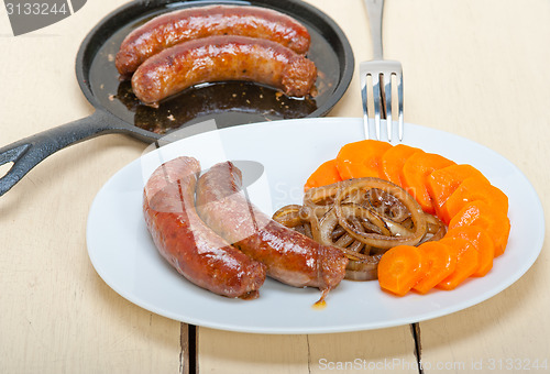 Image of beef sausages cooked on iron skillet 