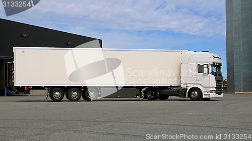 Image of White Semi Trailer Truck on a Warehouse Yard