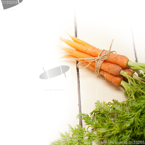 Image of baby carrots bunch tied with rope