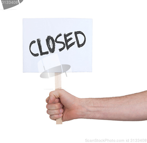 Image of Hand holding sign, isolated on white