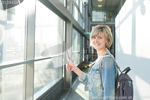 Image of Woman with backpack going on boarding