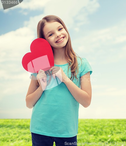 Image of smiling little girl with red heart