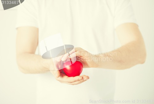 Image of man hands with heart