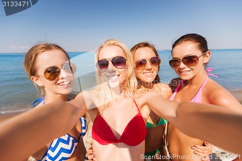 Image of group of young smiling women making selfie