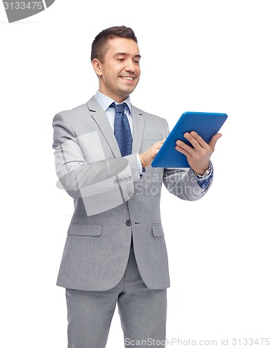 Image of happy businessman in suit holding tablet pc
