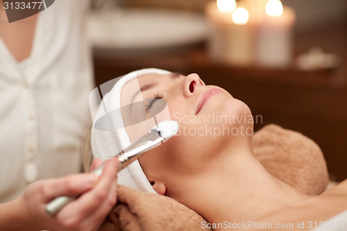 Image of close up of young woman and cosmetologist in spa
