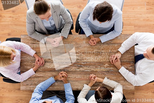 Image of close up of business team sitting at table