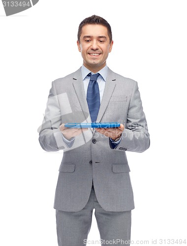 Image of happy businessman in suit holding tablet pc