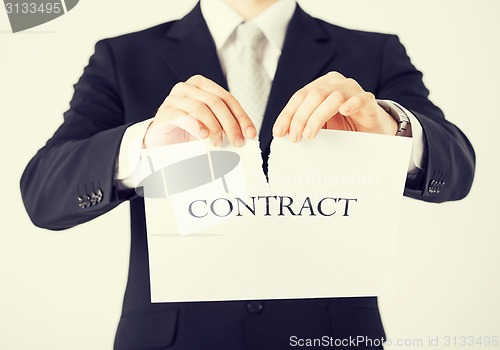 Image of man hands tearing contract paper