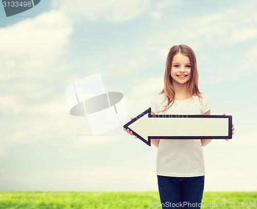 Image of smiling girl with blank arrow pointing left