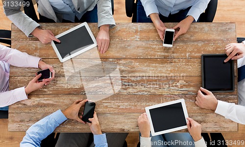 Image of business team with smartphones and tablet pc