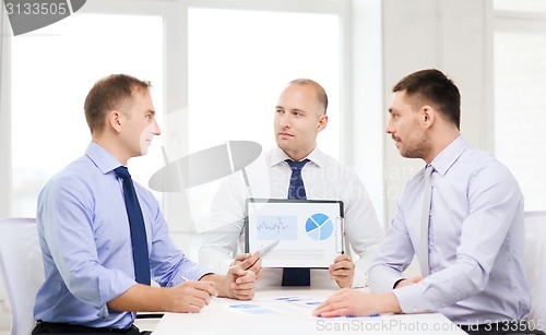 Image of serious businessmen with papers in office