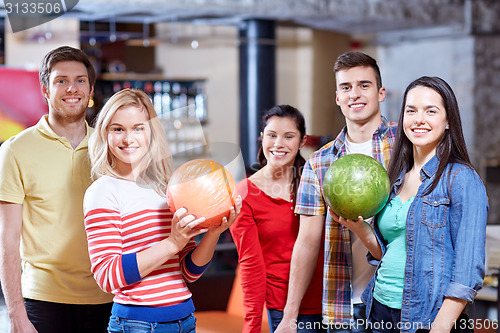 Image of happy friends in bowling club