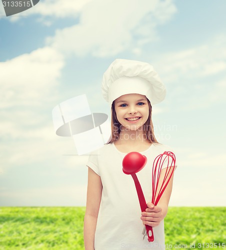 Image of smiling girl in cook hat with ladle and whisk