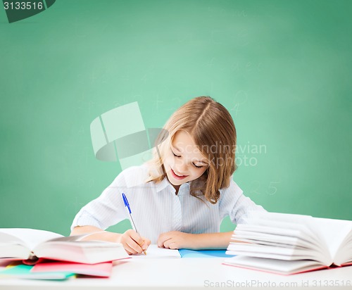 Image of happy girl with books and notebook at school