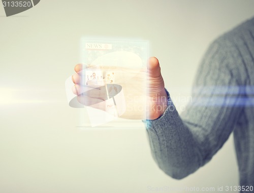 Image of man showing tablet pc with news