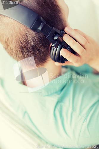 Image of close up of man in headphones at home