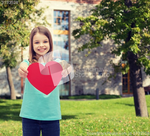 Image of smiling little girl giving red heart