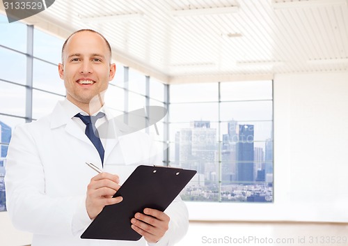 Image of smiling male doctor with clipboard